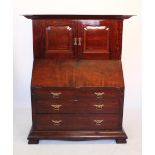 A late 19th/early 20th century mahogany bureau with cupboard, by Orme and Sons, Manchester, the