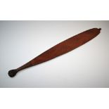 An Australian Aboriginal carved wooden woomera or spear thrower, 84cm long