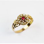 A French 18ct gold floral cluster ring, comprising a central red paste claw with a surround of ten