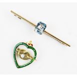 An Edwardian heart-shaped enamel brooch, comprising a central pearlescent cabochon claw set to a