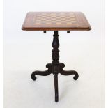 A Victorian mahogany pedestal games table, the square moulded top centred with an inlaid chequered