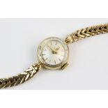 A lady's 9ct gold vintage Omega wristwatch, the cream coloured dial with gold-toned baton markers,