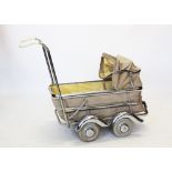 A mid 20th century pram by Pericles, with a folding canopy above roadster type chrome fender and