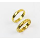A 22ct gold wedding band, with engraved decoration to exterior, ring size N, together with another