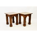 A pair of Gothic influence oak lamp or side tables, 20th century, the square tops centred with a