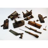 A collection of late 19th century woodworking tools, to include two plough planes with brass