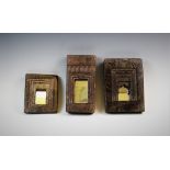A set of three carved wood mirrors, each set to a rectangular panel surround, with geometric