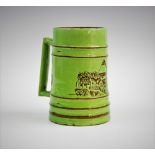 A green glazed beer mug, A. W. Finch for The Iris Works, Porvoo, Finland, circa 1901, the ribbed mug