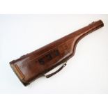 A 19th century leather leg of lamb gun case, applied with brass 'D'rings, leather loop handle and