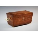 A George IV rosewood tea caddy, of sarcophagus form, applied with ivory ring handles, upon ivory