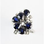 A sapphire and diamond cluster ring, the tiered cluster comprising six untested teardrop shaped blue