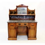 A late Victorian walnut tile back washstand by Lamb of Manchester, with an architectural pediment