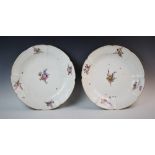 A near pair of Meissen porcelain chargers, 19th century, each of circular form with shaped rims,