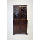 A 19th century campaign style glazed cabinet, with a moulded cornice above a pair of astragal glazed