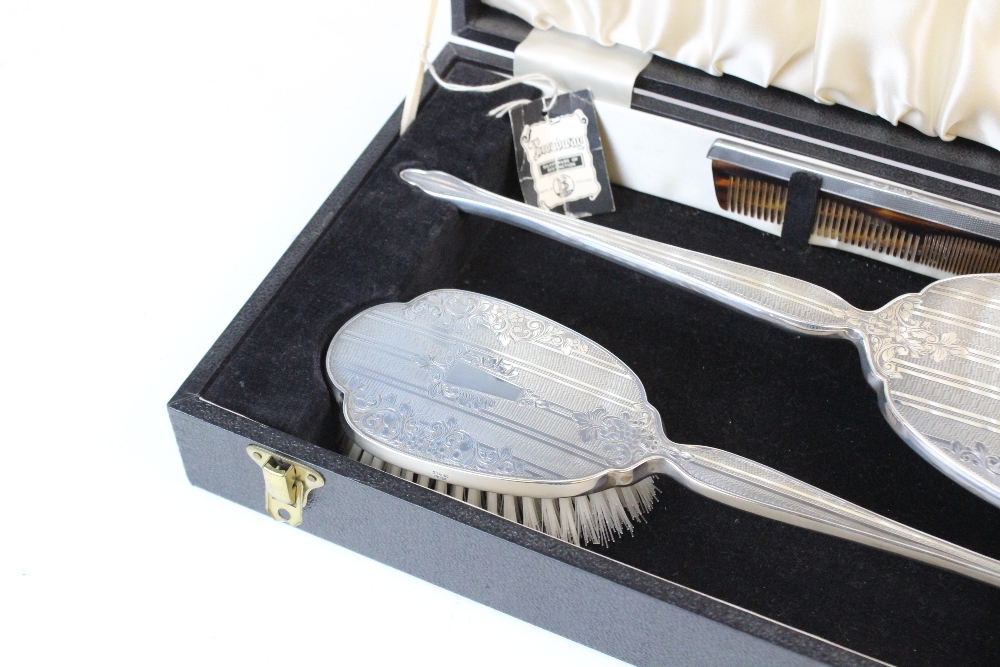 A silver backed dressing table set, W I Broadway & Co, Birmingham 1976, comprising: a hand mirror, a - Image 3 of 3