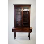 A George III mahogany bookcase on associated secretaire base, with a moulded cornice above a pair of