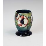 A Moorcroft vase of ovoid form on spreading foot, decorated in the Anemone pattern against a green