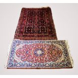 A Caucasian wool rug, with a central recurrent diamond and geometric design upon a dark ground,