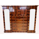 A late Victorian flame mahogany compactum wardrobe by Howard & Sons, Berner St, London, with a