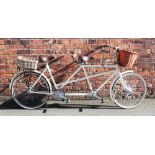 A mid 20th century tandem bicycle, with an over painted frame, gents pilot seat with cross bar