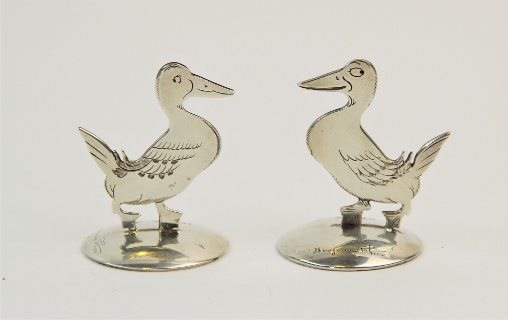 A pair of silver place card holders, Sampson Mordan & Co Ltd, Chester 1912/1914, each modelled as