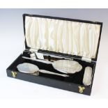 A silver backed dressing table set, W I Broadway & Co, Birmingham 1976, comprising: a hand mirror, a