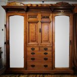A late Victorian walnut compactum wardrobe, by Lamb of Manchester, with twin architectural