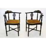 A pair of Edwardian inlaid corner chairs, the curved top rail raised upon two pierced inlaid