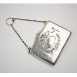 An Edwardian silver purse, Henry Matthews, Birmingham 1909, of typical form, with garland swag and