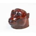 A treen monkey head tobacco jar, the carved wooden head with amber glass eyes, hinged lid opening to