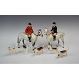 A Beswick hunting group, comprising; a huntsman and a huntswoman each riding a grey horse, each 21.