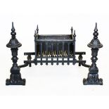 A Regency style cast iron fire basket, 20th century, with a pair of urn shaped finials above a