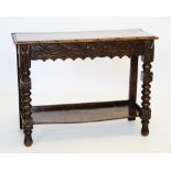 A Victorian carved oak side table, the rectangular moulded top above a frieze carved with a