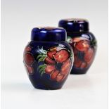 Two Moorcroft ginger jars and covers of typical form and small proportions, each decorated in the