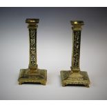 A pair of late 19th century French brass filigree candlesticks, the stepped square sconce