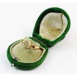 An early 20th century 18ct gold floral cluster ring, comprising a central mixed cut diamond with a