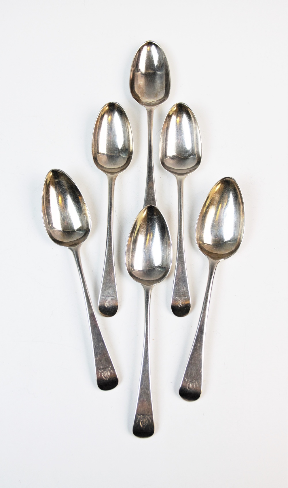 A selection of silver spoons, comprising; three George III silver Old English pattern dessert