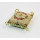 An early 19th century pin cushion, of square form, designed with hand sewn floral motifs, in a blue,