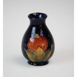 A Moorcroft vase of baluster form and small proportions, decorated in the Pomegranate pattern