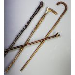 A hardwood walking cane, with a figural mask terminal extending to a rope twist shaft, 100cm, a