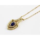 A sapphire and diamond metamorphic pendant, comprising a central pear-shaped sapphire measuring