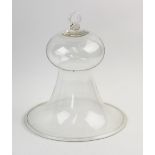 A Victorian glass cloche, of bell form with a folded rim, applied with a ring handle, 28cm high x