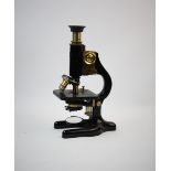 A mid 20th century black lacquered and brass microscope, by W R Prior, 9-11 Earle St, London, with