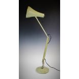 A mid 20th century angle poise lamp, with a bell shaped painted metal shade, upon a sprung