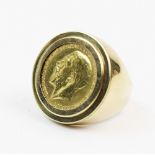 A George V sovereign dated 1911, set to a 9ct gold gentlemen's dress ring of tapering form, ring