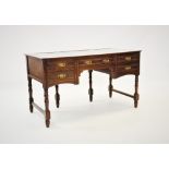 A late Victorian walnut desk or dressing table, the rectangular top later converted with three