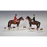 A Beswick hunting group, comprising; a huntsman and a huntswoman each riding a bay horse, each 21.
