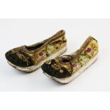 A pair of early 19th century Chinese silk embroidered shoes, decorated against a yellow silk