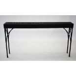 A cast iron garden or conservatory table, of narrow rectangular form, with a pair of cast open