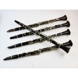 A collection of five early 20th century and later rosewood coloured clarinets, comprising, an E J